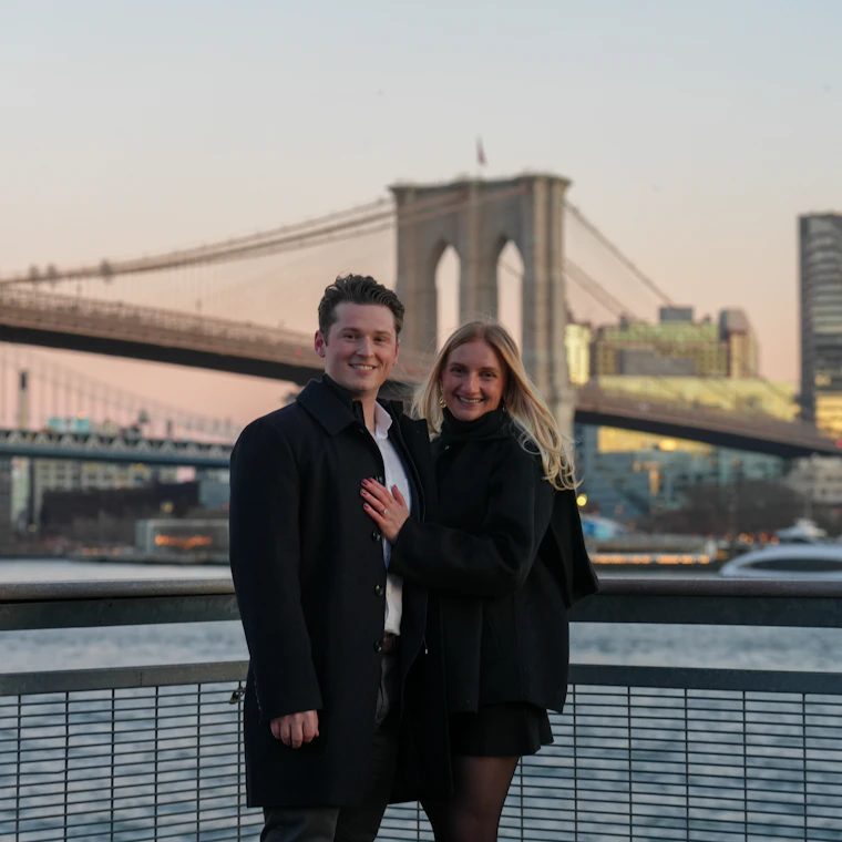 A couple celebrating together by the Manhattan skyline at golden hour